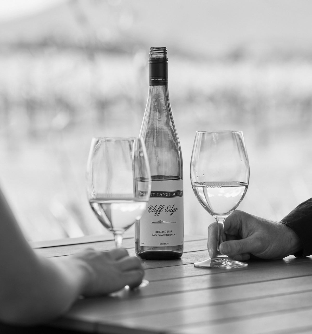 Man and woman share a bottle of Mount Langi Ghiran Cliff Edge Riesling